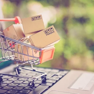 A shopping cart with boxes sitting on top of it.