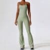 Female model in green athletic outfit.