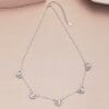 Silver necklace with heart-shaped pendants.