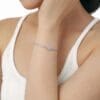 Woman wearing elegant silver bracelet.