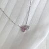 Pink and clear gemstone necklace on fabric.