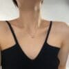 Woman wearing a heart-shaped necklace.