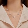 Silver heart necklace on beige blouse.