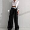 Cropped white shirt with wide black trousers.