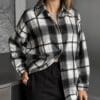 Woman in black and white plaid shirt.