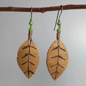 Leaf-shaped earrings with green beads.