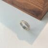 Elegant silver and gold ring with gemstones.
