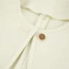 Light green textured fabric with button detail.