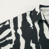 Black and white striped shirt detail.