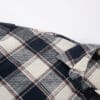 Plaid shirt with navy and cream patterns.