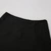 Black fabric close-up of a skirt.