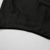 Black fabric draped on a white surface.