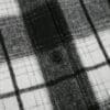 Black and white plaid fabric with button.