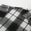 Black and white plaid flannel shirt close-up.
