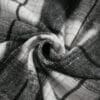 Gray and white plaid fabric in a swirl.