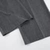 Gray fabric folded trousers on white background.