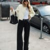 Woman in stylish outfit on urban street.