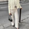 Chic woman in cream jacket and trousers.