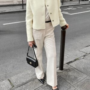 Chic woman in cream jacket and trousers.