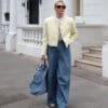 Woman in stylish outfit walking outside.