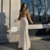 Woman in stylish gold sweater and long skirt.