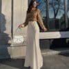 Woman in stylish sweater and long skirt.