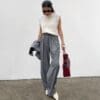Stylish woman in gray trousers and sweater.